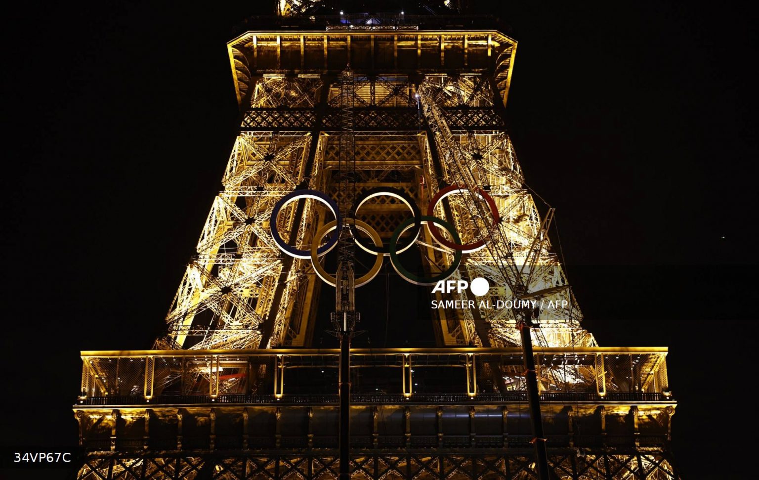 AFP__20240606__34VP67C__v4__Mockup__OlympicsOlympicRingsUnveiledOnParisSEiffelTower5-1536x971