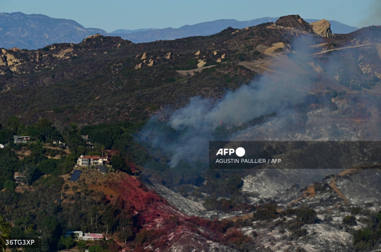 A-house-stands-intact-as-the-hillside-is-scorched-by-the-Palisades-Fire-in-Fernwood-Topanga-a-community-in-western-Los-Angeles-County-California-in-January-10-2024.-